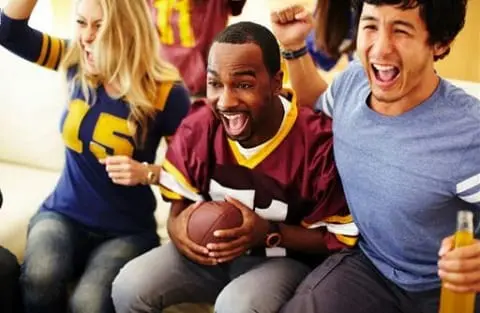 Fans celebrating at a Super Bowl party