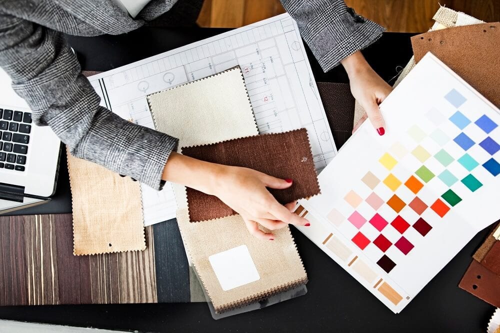 Woman looking at fabric samples and color swatches