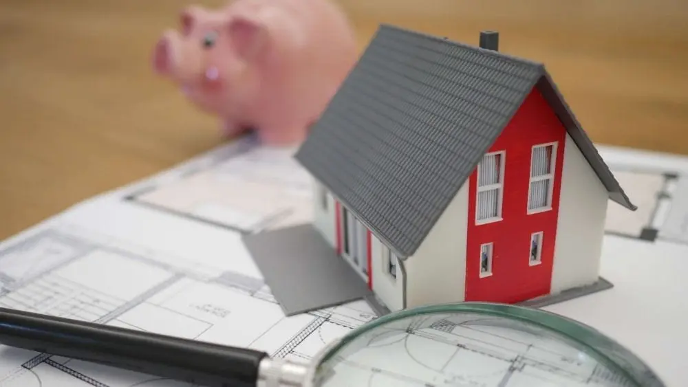 A house with on a loan with a piggy bank in the background