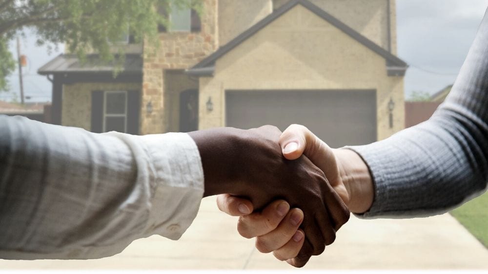 handshake-in-front-of-house
