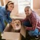 couple and dog with moving box