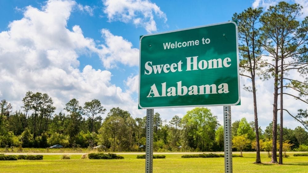 State sign that reads "Welcome to Sweet Home Alabama."