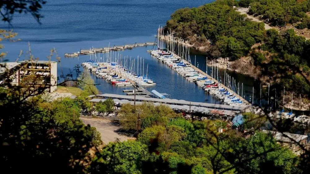 Distanced aerial view of a boat dock lined with private boats.