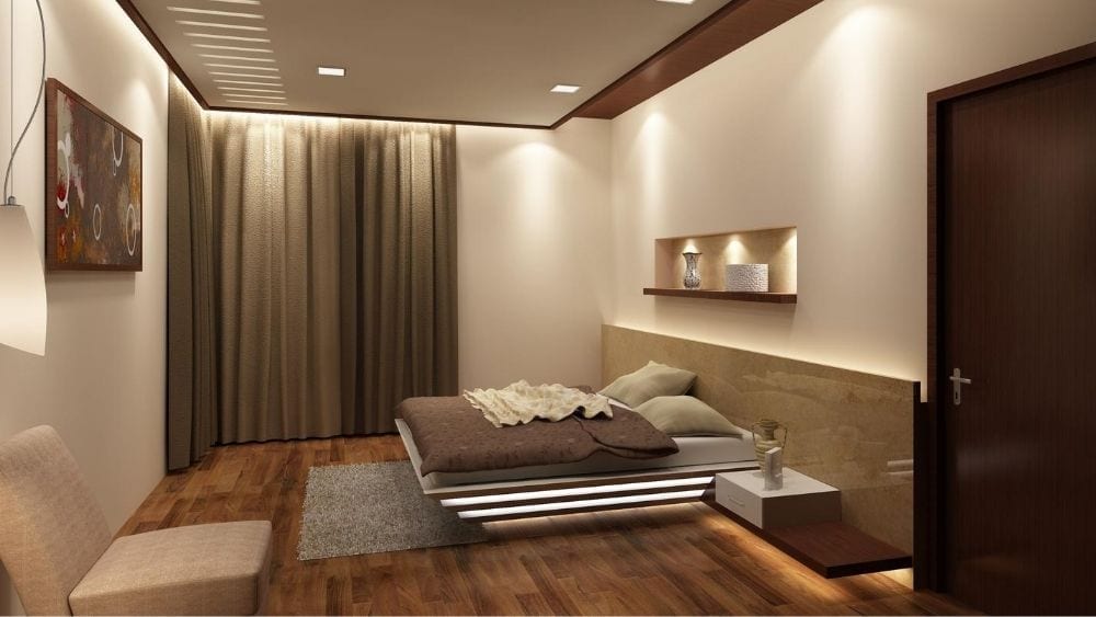 A neutral bedroom with tiered under bed lighting