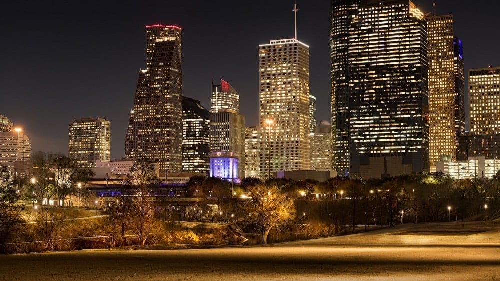 Downtown Houston high-rise buildings illuminated at night.