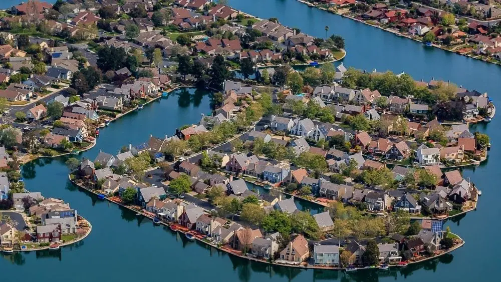 A network of waterways wrapping around islands with new houses on them.
