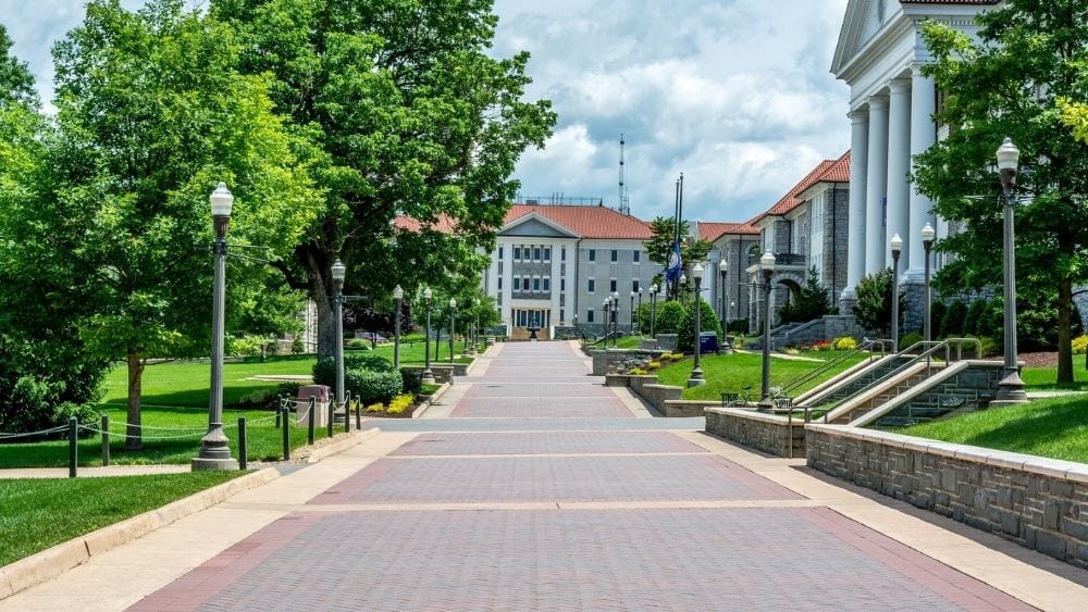 A cobblestone path leading to a stately building on James Madison University campus in Harrisonburg, Virginia.