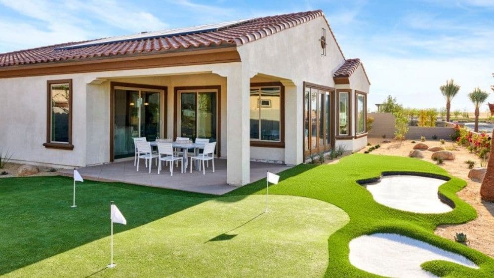 A miniature golf course in the backyard of a Spanish-style home.