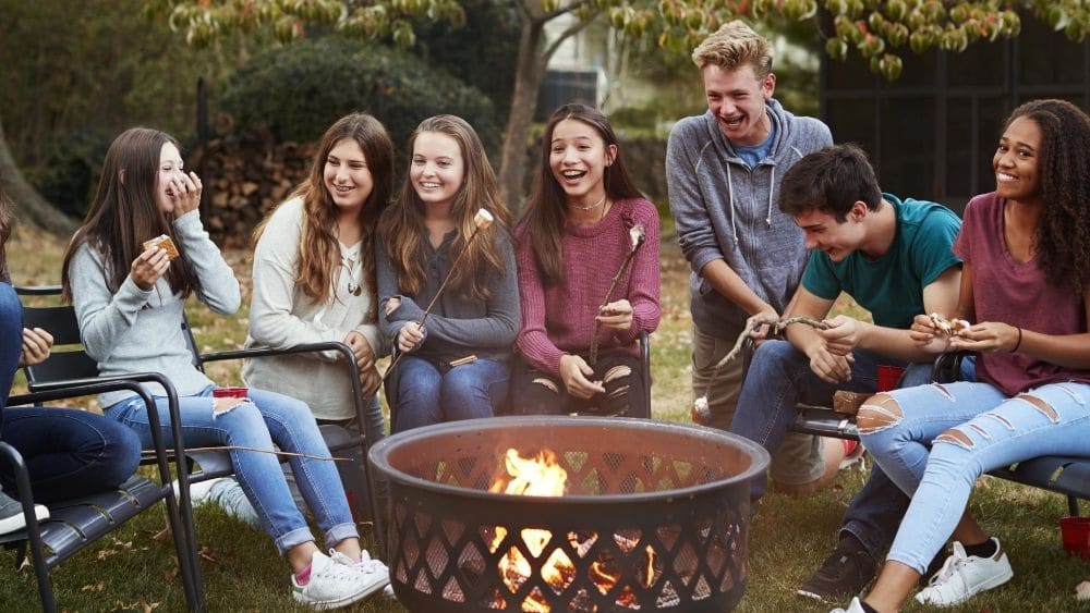 people sitting around the fire pit