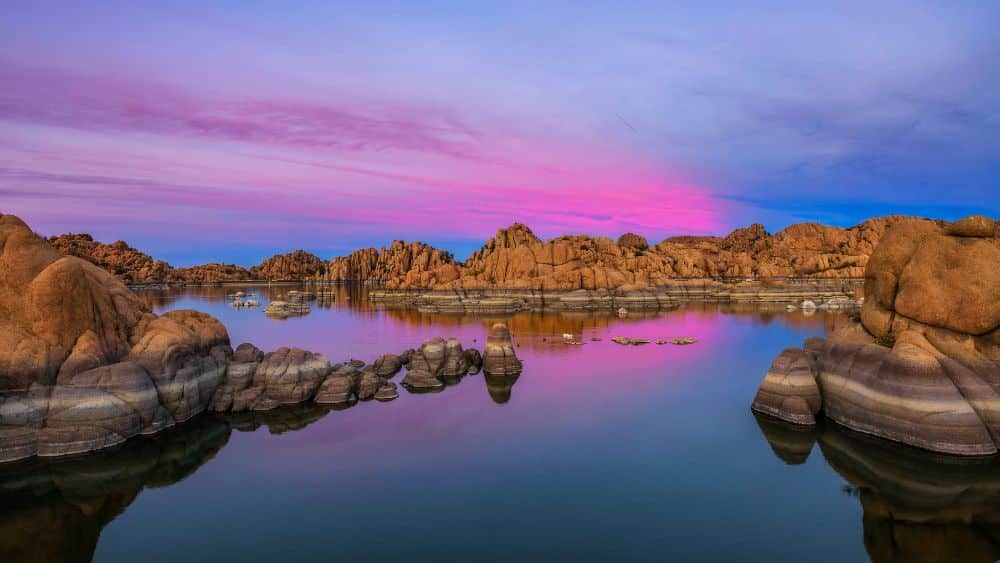 Pink and blue sunset over a lake in Prescott, Arizona.