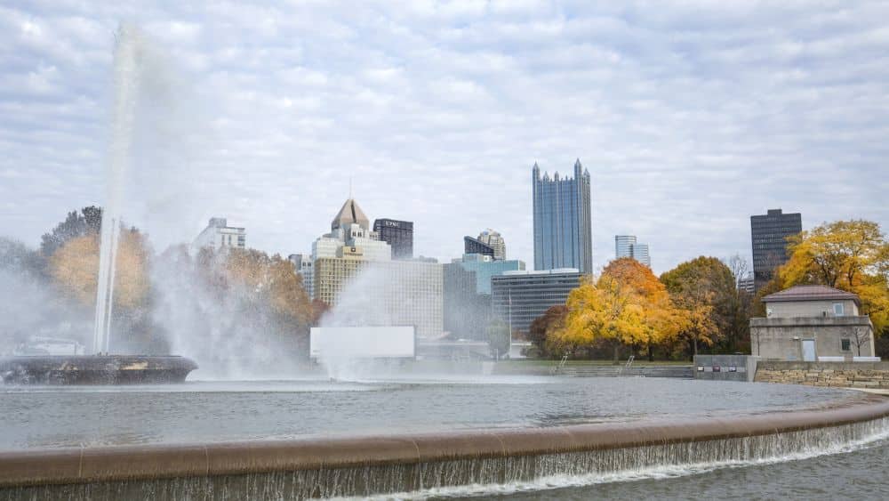 A fountain with a skyline in the background.