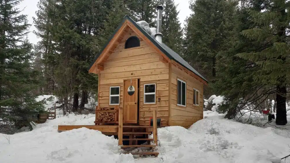 quaint rustic tiny home in the winter woods alaska