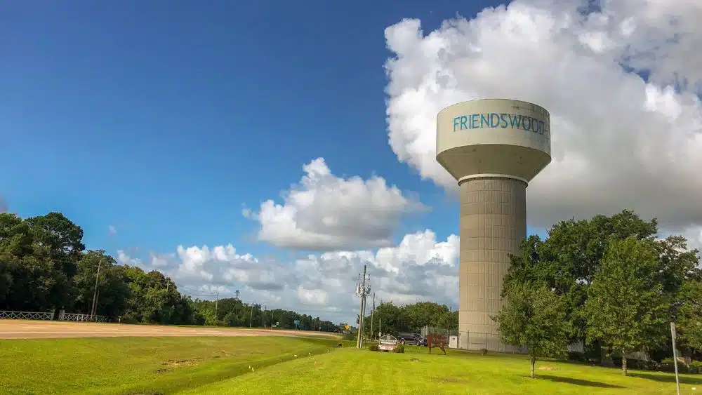 Water tower that reads "Friendswood" towering over a field.