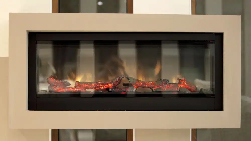 A modern electric fireplace with fake logs glowing.
